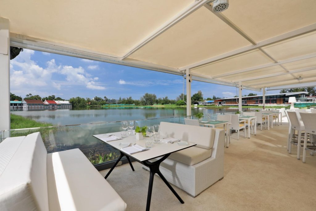 Covered terrace with lounge seating and lake view