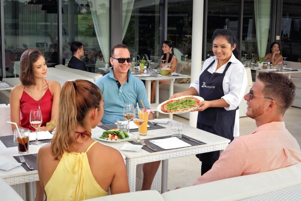 Waitress serving guests on the terrace at Bocconcino