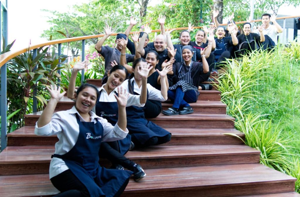Bocconcino team waving on the restaurant steps